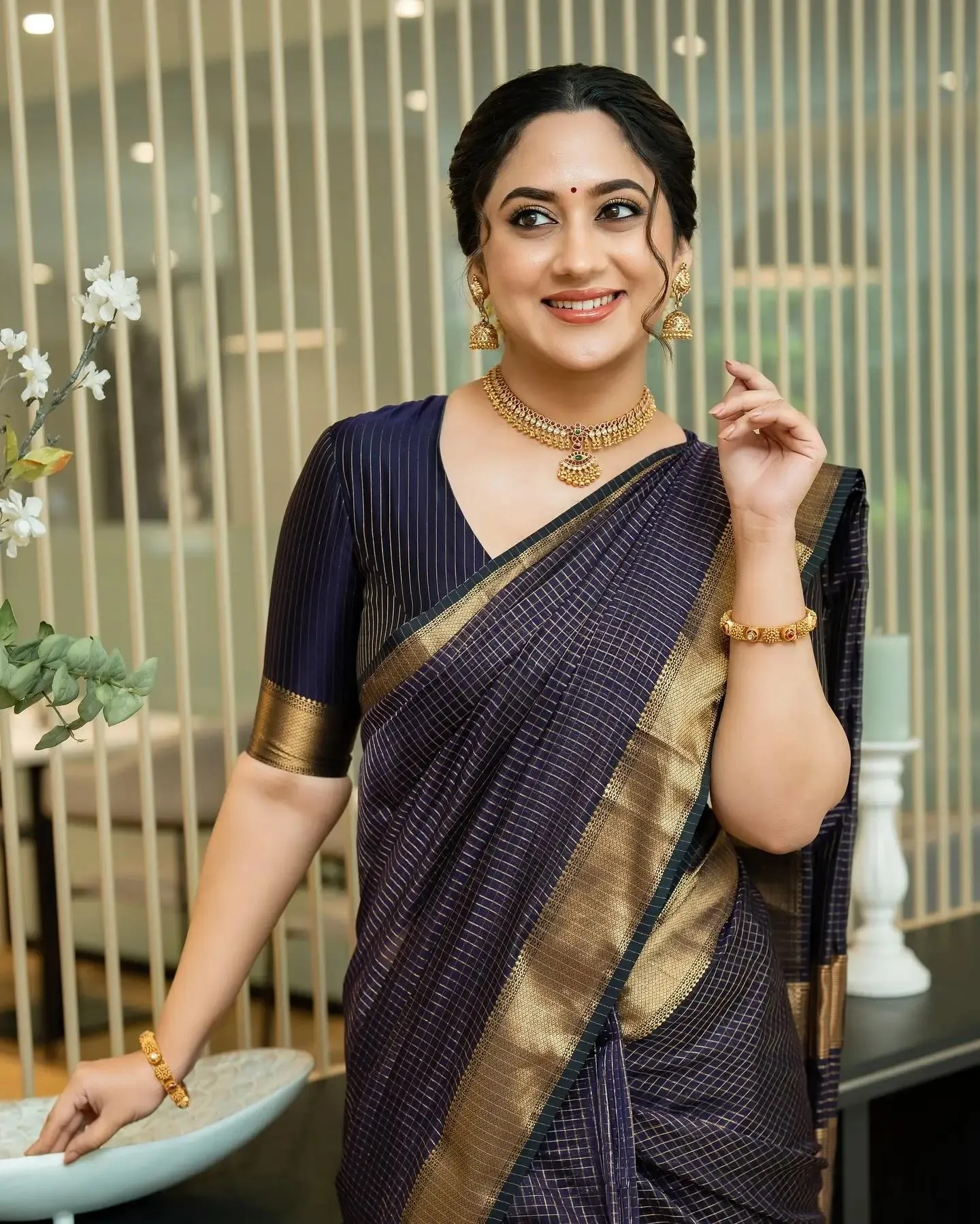 Attractive Miya George in Dark Saree Outdoor Pose Wallpaper