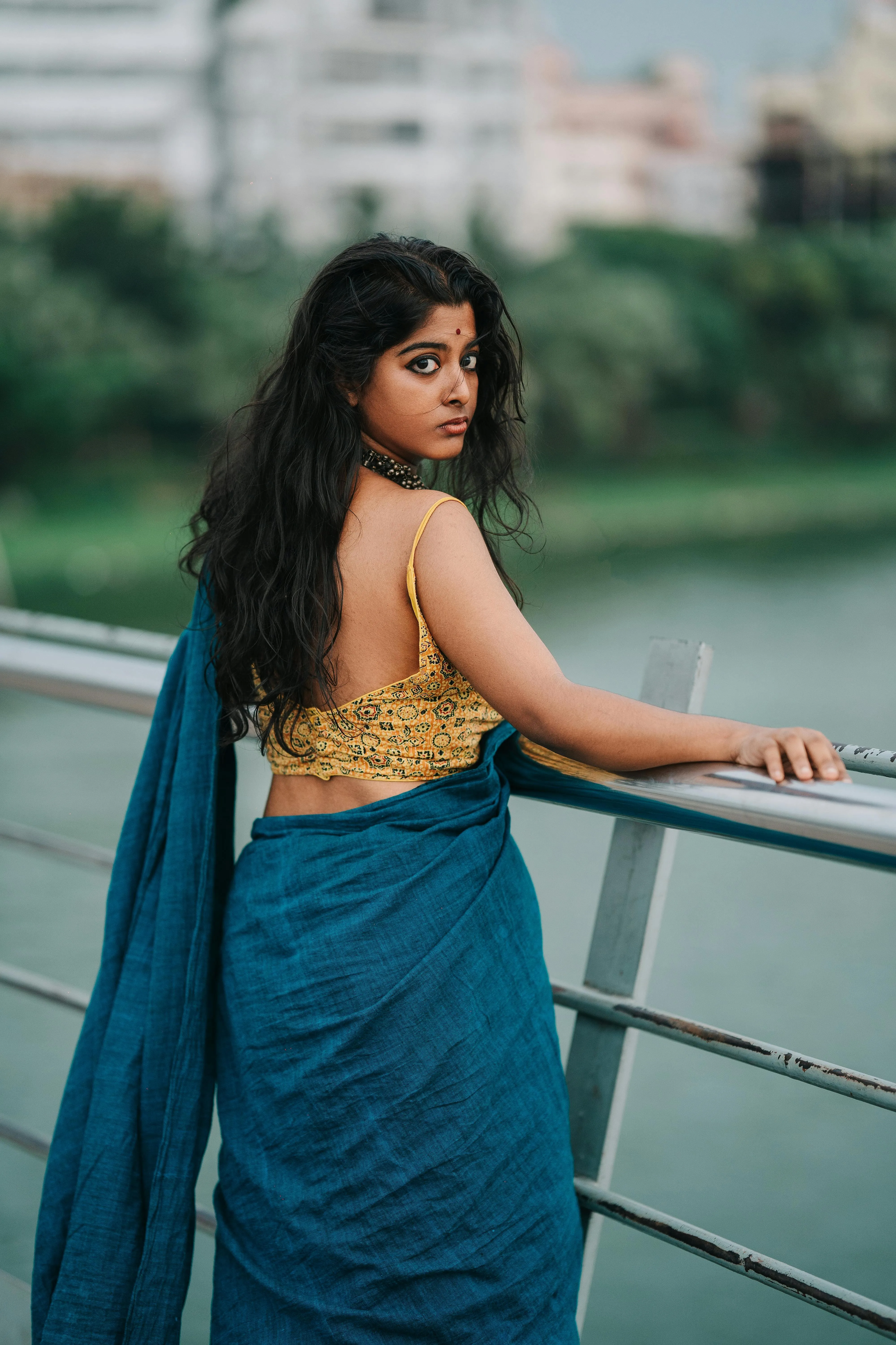Attractive Young Woman in Blue Saree Posing on Balcony Image