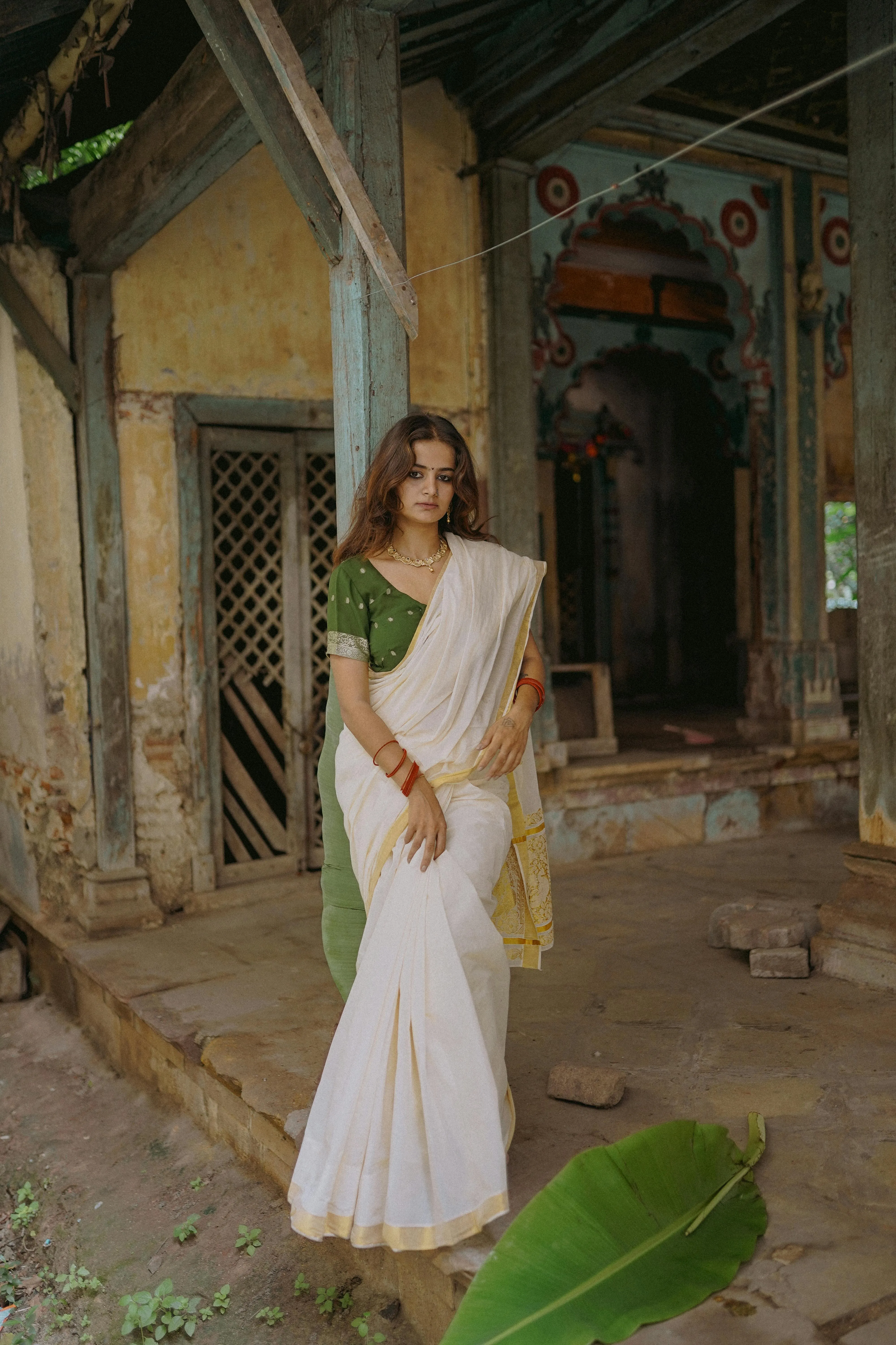 Attractive Young Woman in White Saree Near Vintage Door