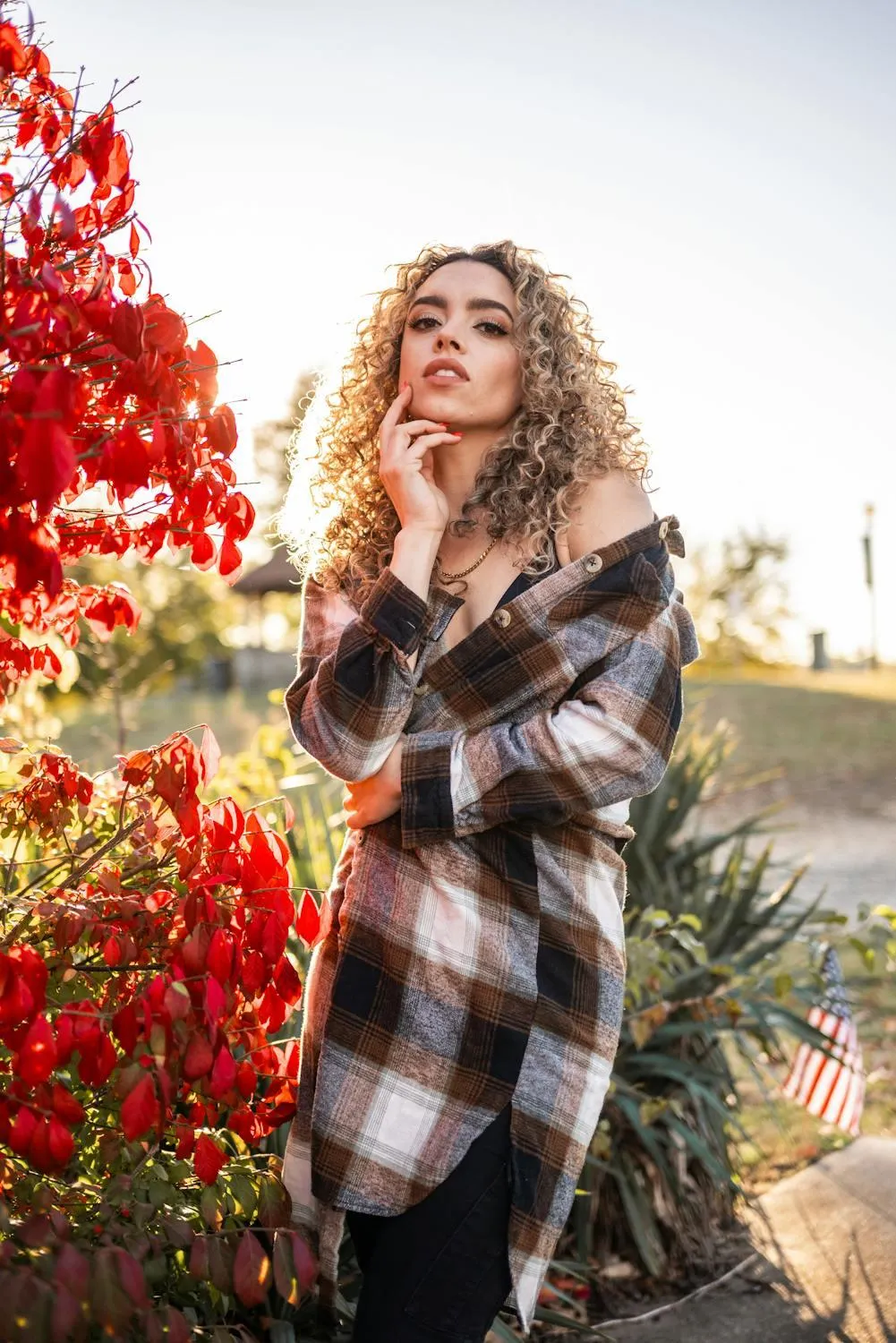 Autumn Outfit of a Woman Standing Near Red and Green Trees