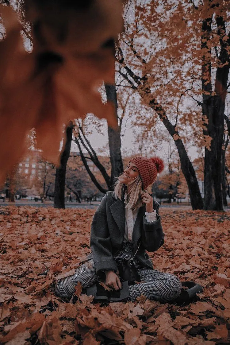 Autumn Themed Photo of a Woman Sitting Calmly in the Woods