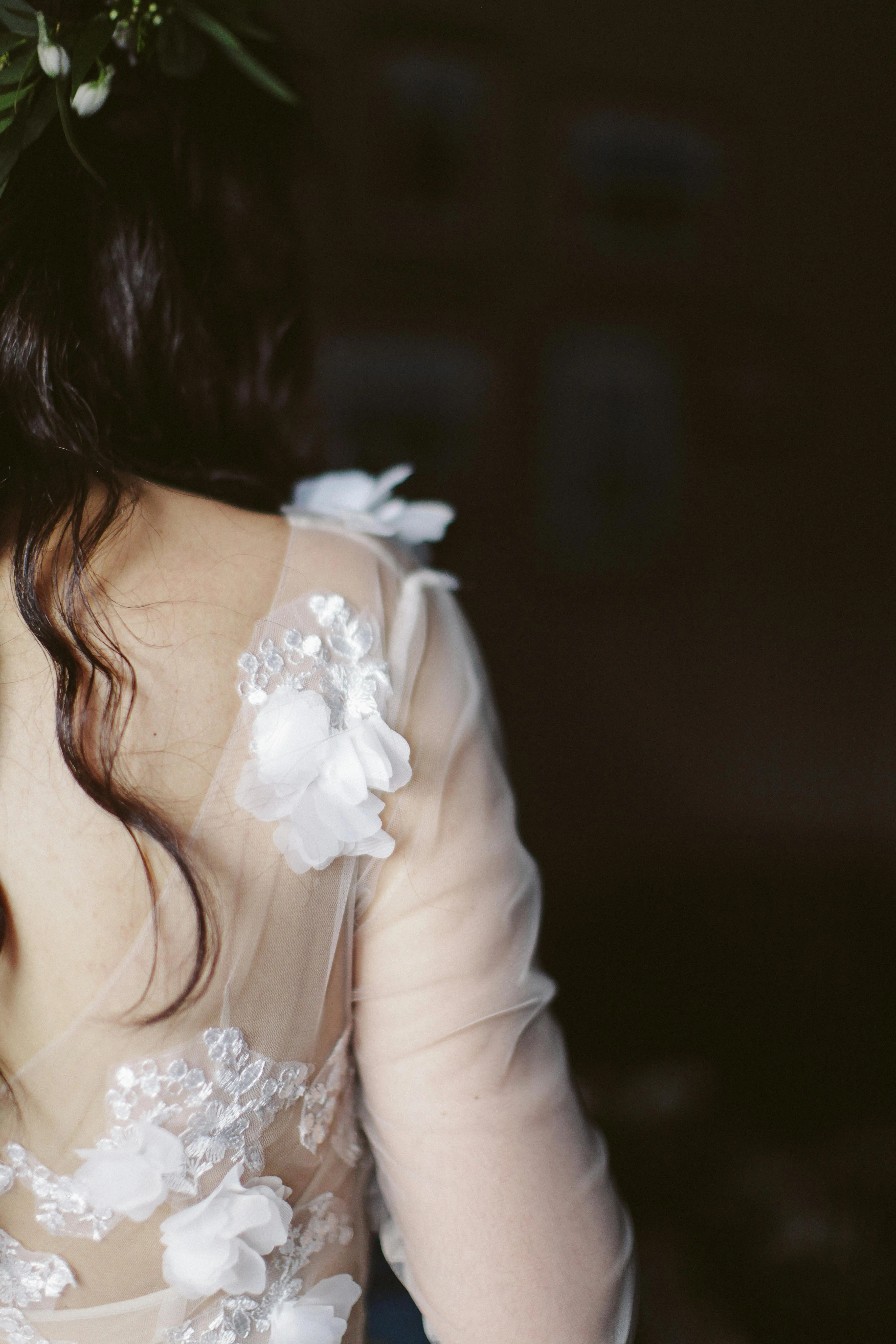 Back View of a Woman in a White Lace Dress At Evening Event