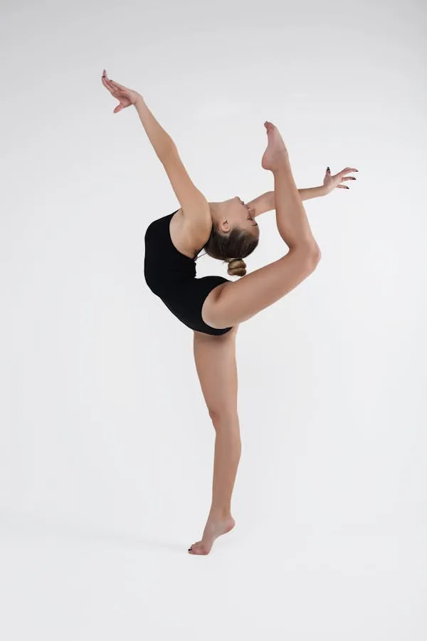 Ballet Dancer in a Black Leotard Performing Mid Air Split