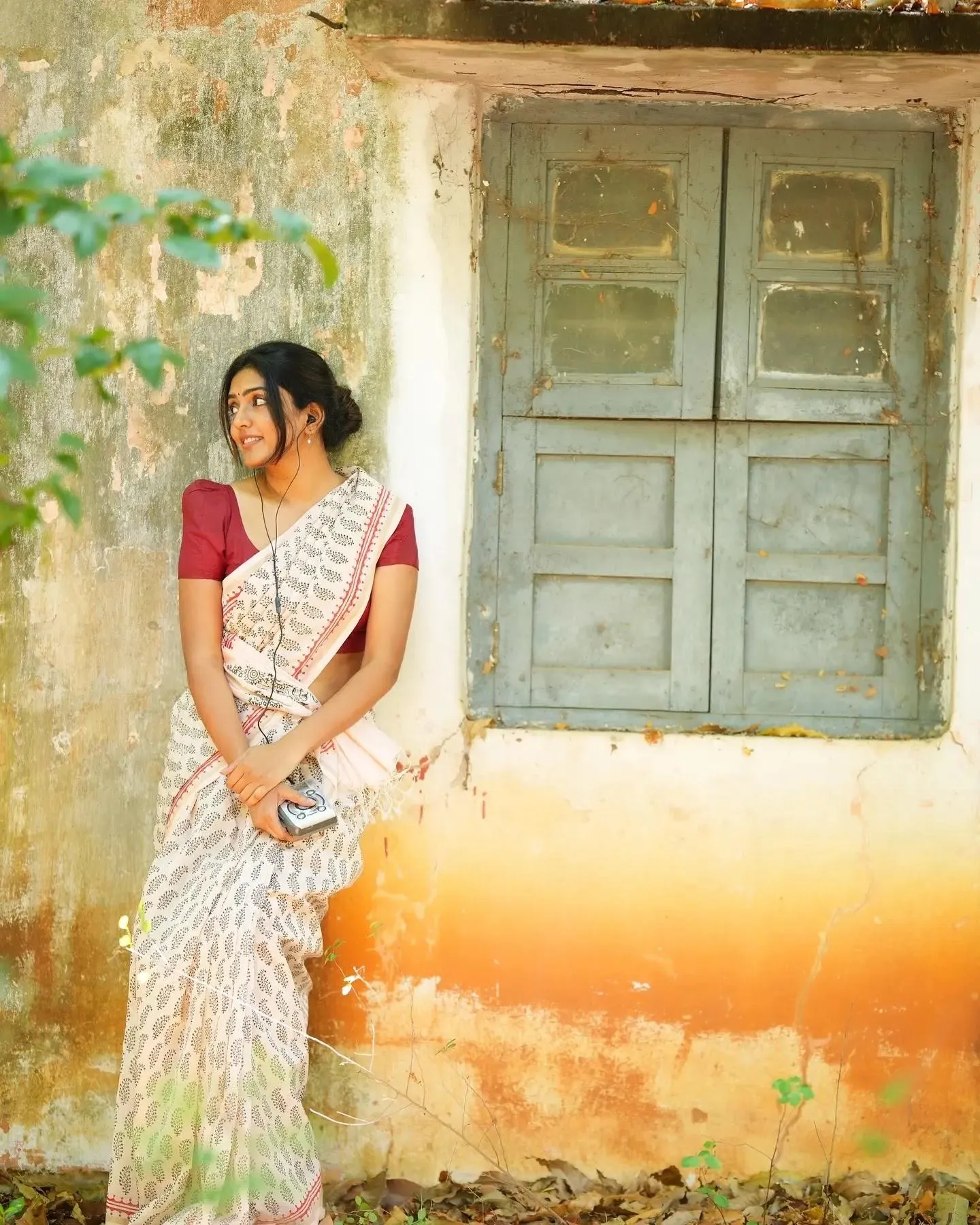 Beautiful Eesha Rebba in White Saree Near a Door Wallpaper