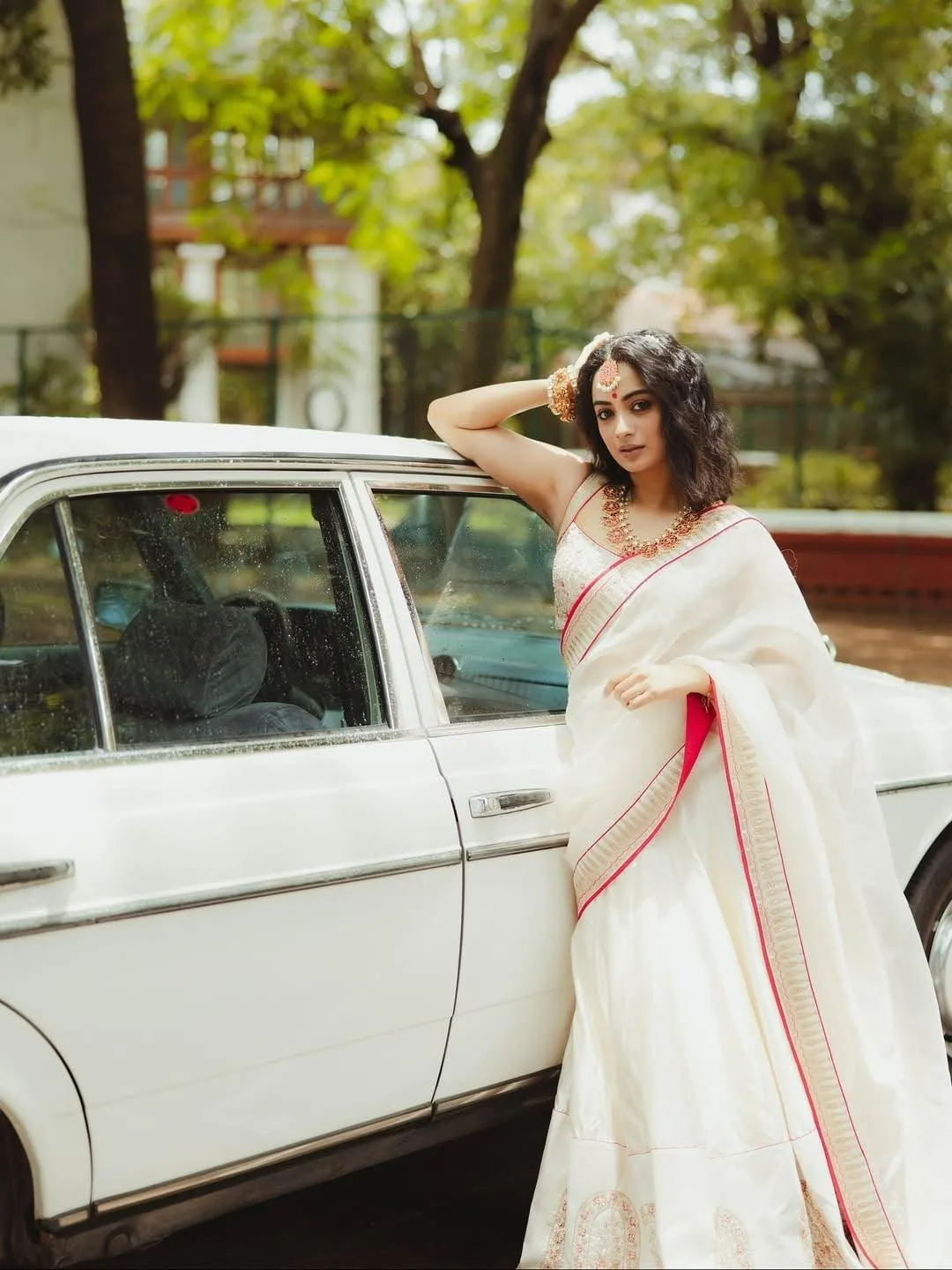 Beautiful Namitha Pramod in White Saree Beside Car Wallpaper