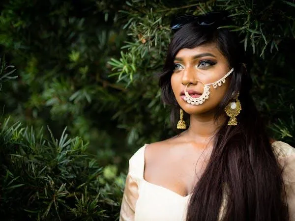 Beautiful Woman with Jewelry Poses Outdoors in Nature Image