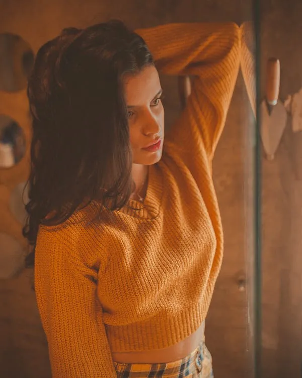 Beautiful Woman Wearing Cozy Orange Sweater Indoor Wallpaper