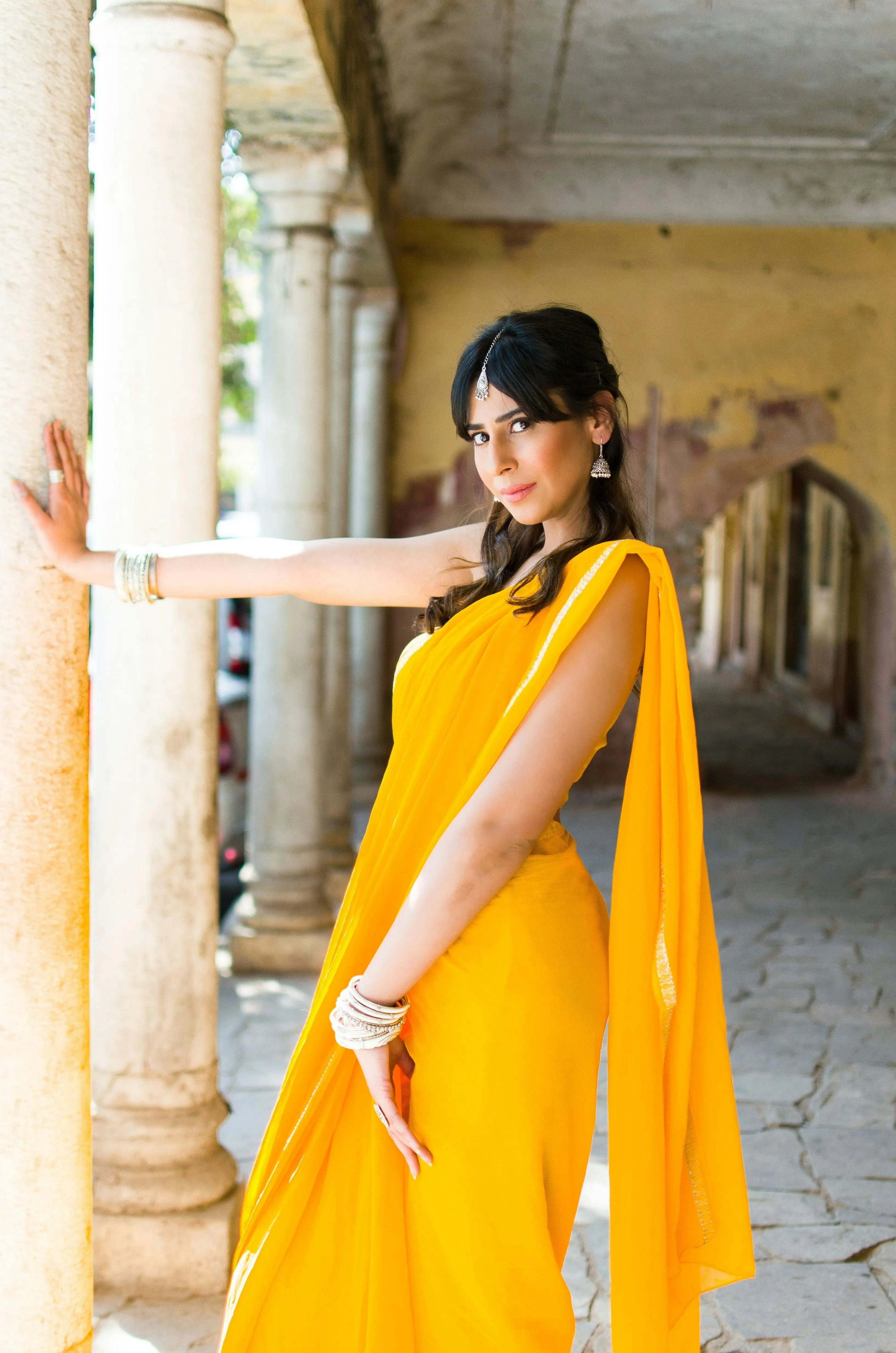 Beautiful Young Woman in Yellow Saree Outdoor Standing Image