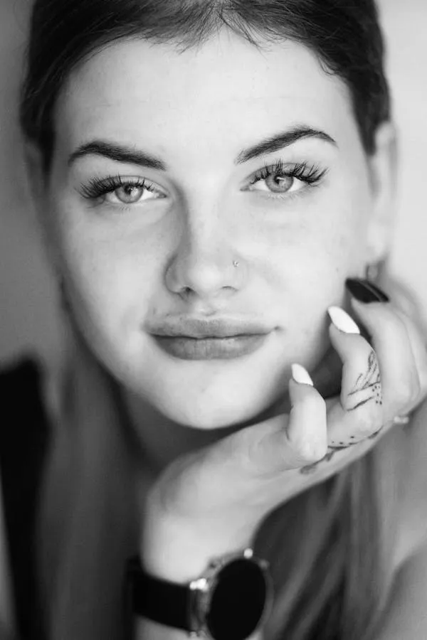 Black and White Close Up of a Woman Resting Her Face on Hand