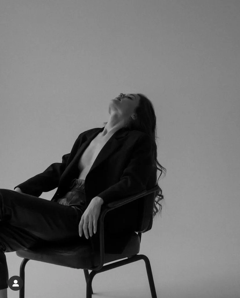 Black and White Image of a Woman Reclining in Chair Relaxed