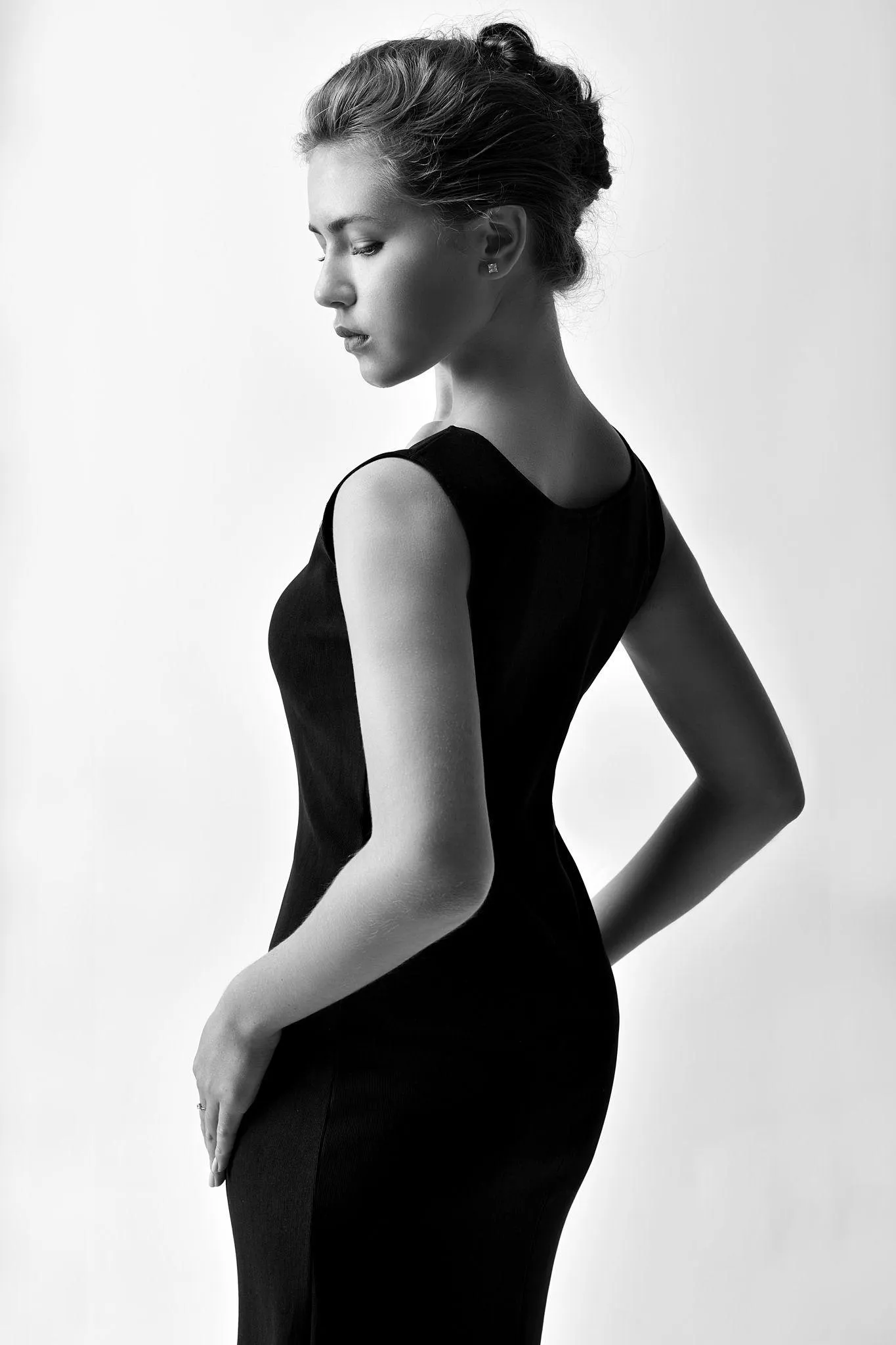 Black and White Photo of an Elegant Woman in a Fitted Dress