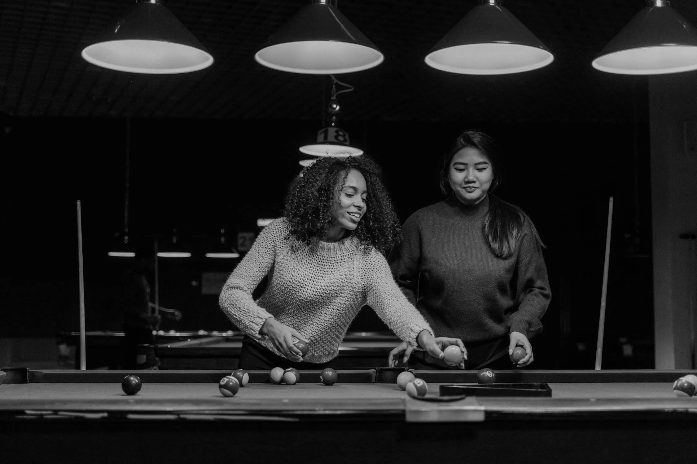 Black and White Photo of Two Women Playing Billiards Image