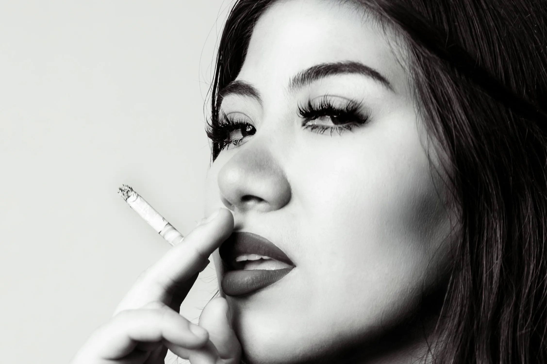 Black and White Photo of a Woman Smoking with a Glamour