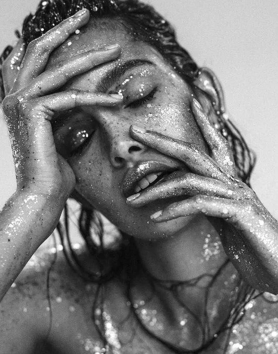 Black and White Portrait of a Woman with Hands on Her Face