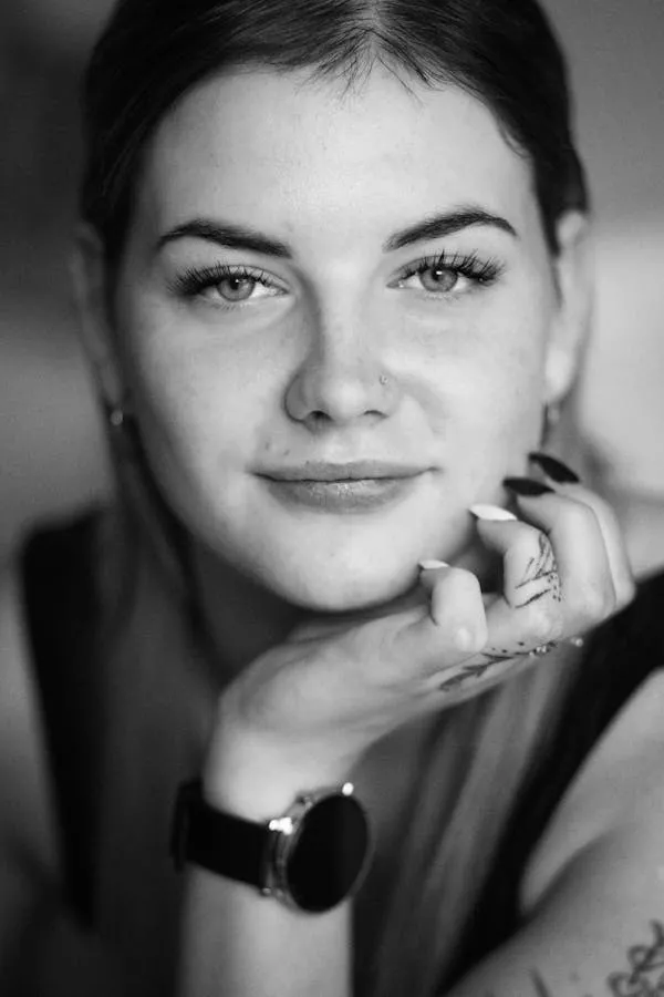 Black and White Portrait of a Woman Resting Chin on Her Hand