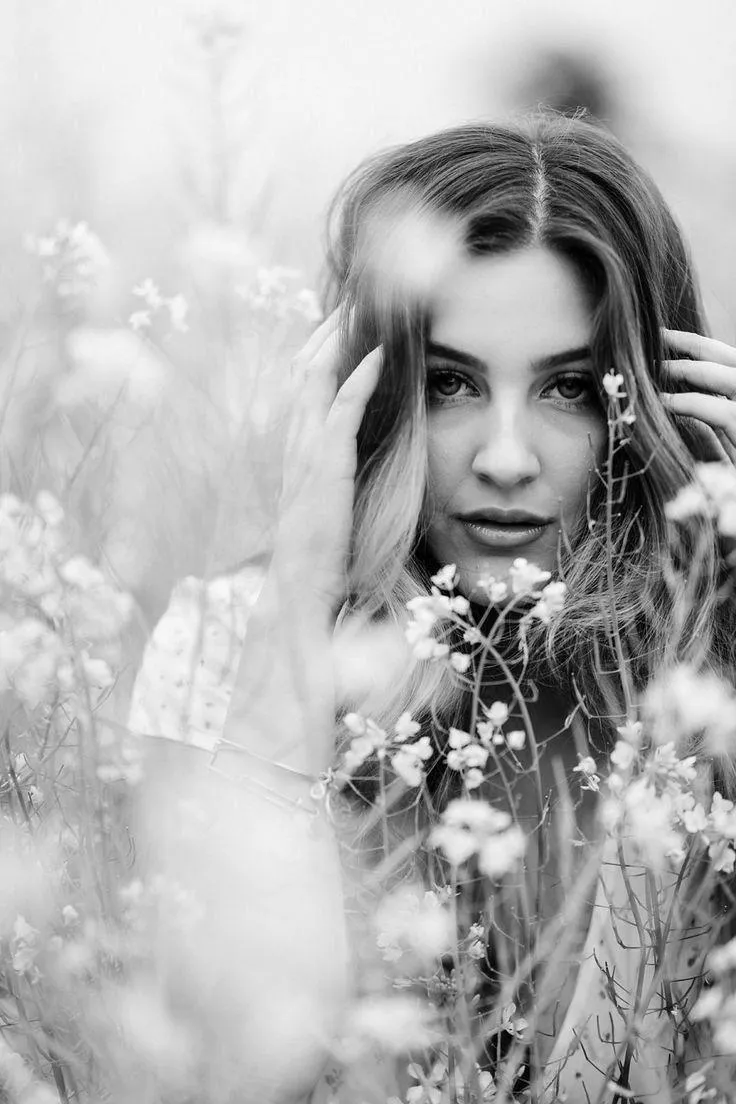 Black and White Portrait of a Woman Surrounded by Flowers