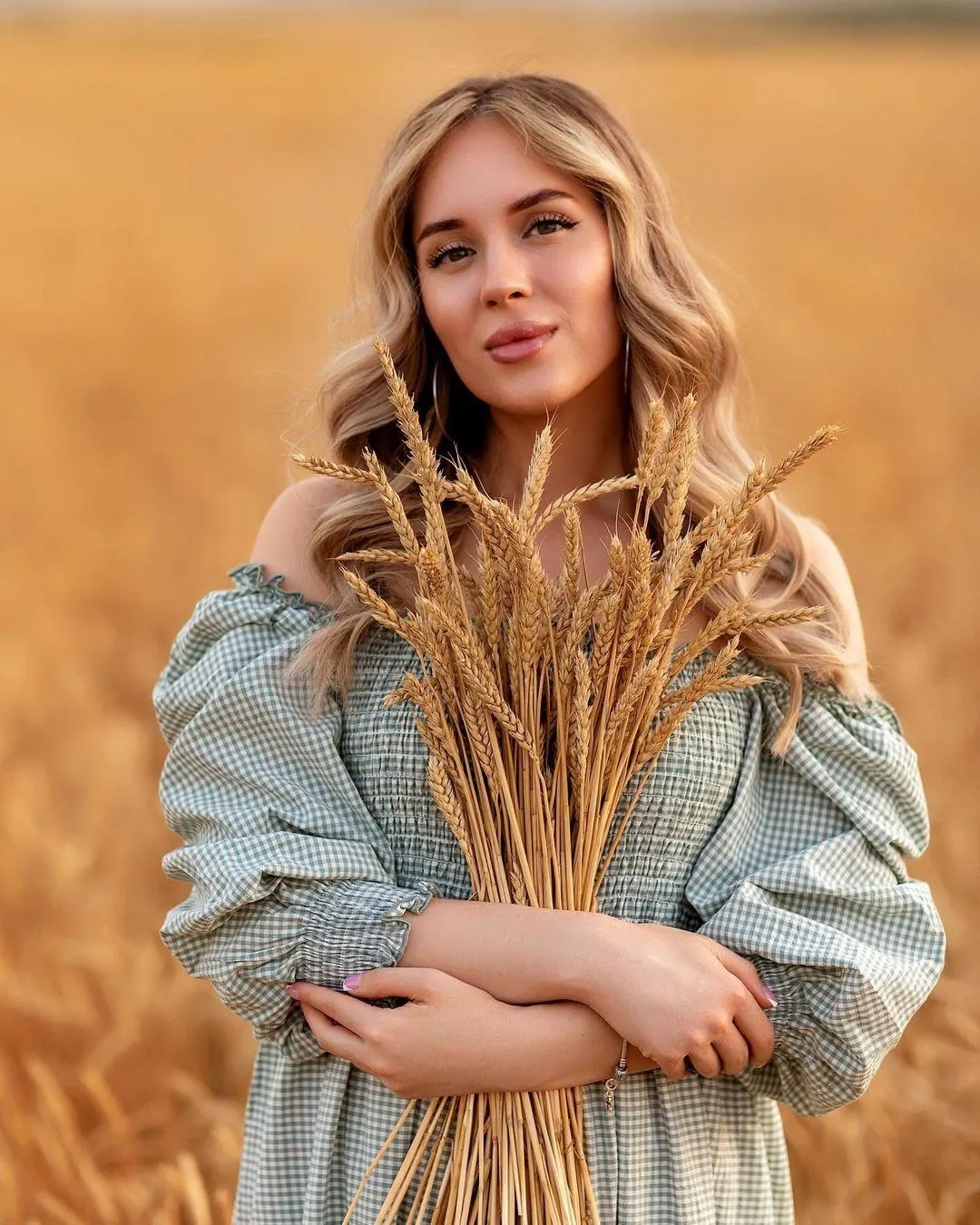 Blonde Woman in Blue Dress Holding Dried Wheat Stalks Image