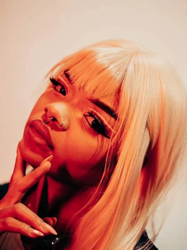 Blonde Woman with Bold Makeup Posing with a Playful Attitude