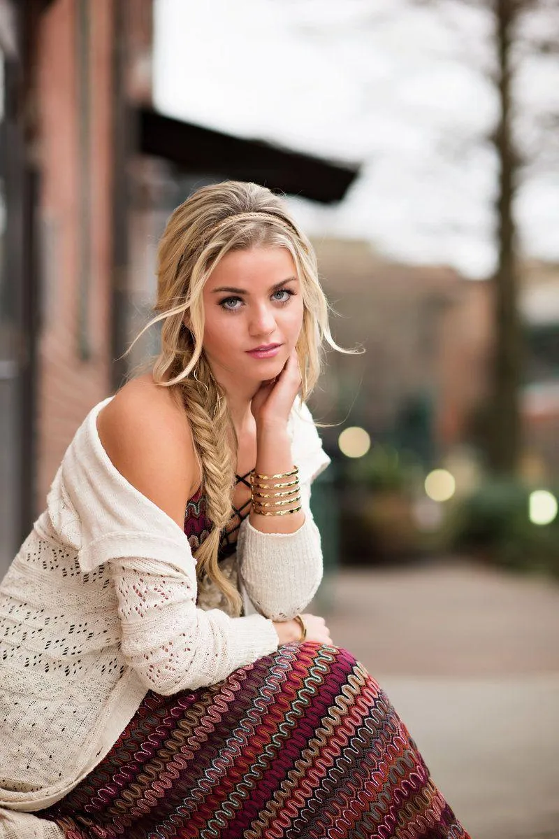 Blonde Woman in a Knit Sweater Posing on a Street Bench