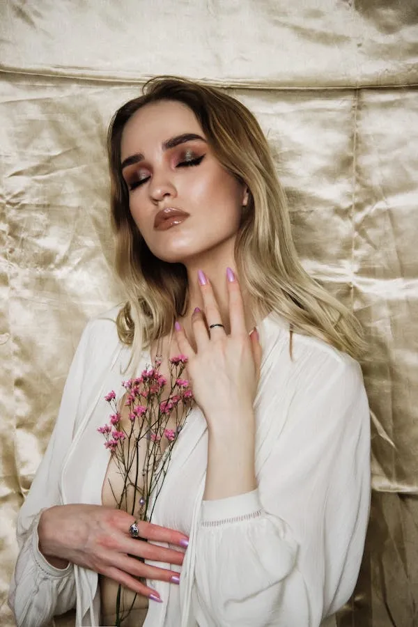 Blonde Woman Leaning on a Textured Wall with Flowers Image