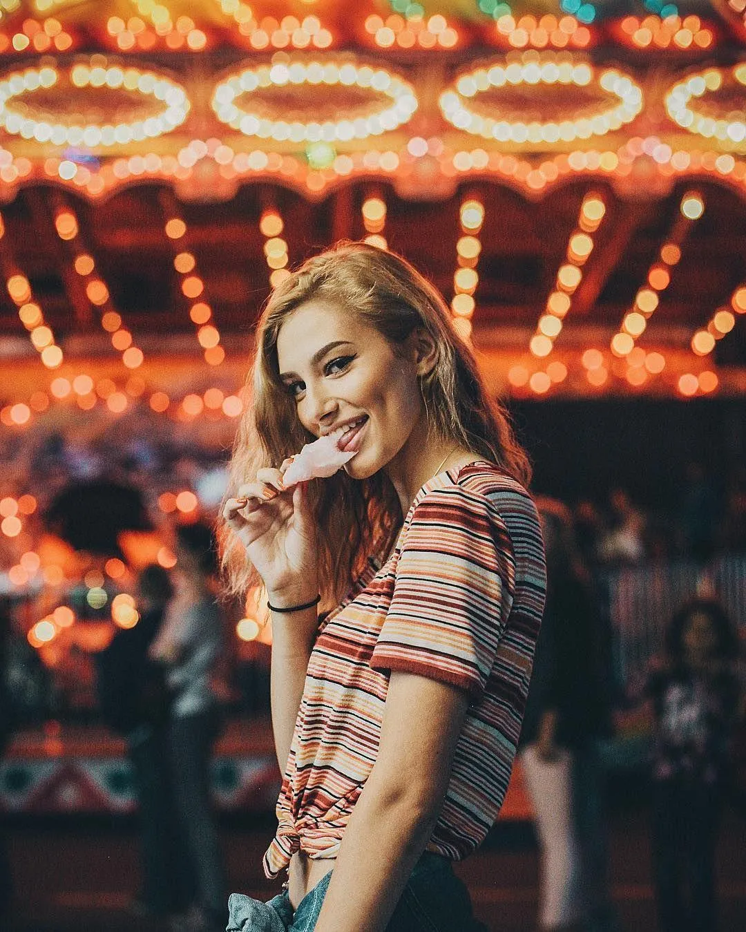Blonde Woman with Soft Makeup Posing Against a Blue Wall