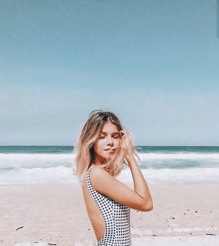 Blonde Woman in a Swimsuit Smiling At a Tropical Beach Image