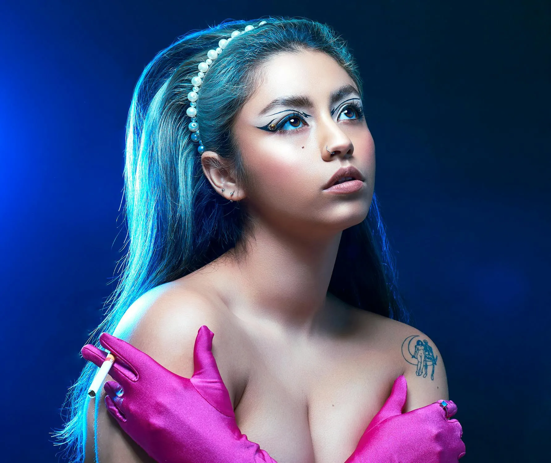 Blue Haired Woman with Bold Makeup in Studio Light Wallpaper