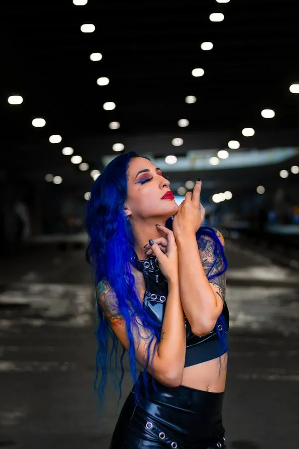 Blue Haired Woman Posing Under the Bright Lights At Night