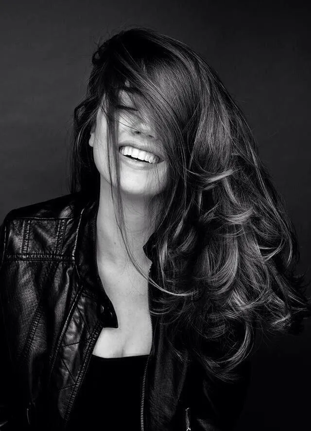 Bold Woman Standing by a Rustic Truck in a Vintage Setting