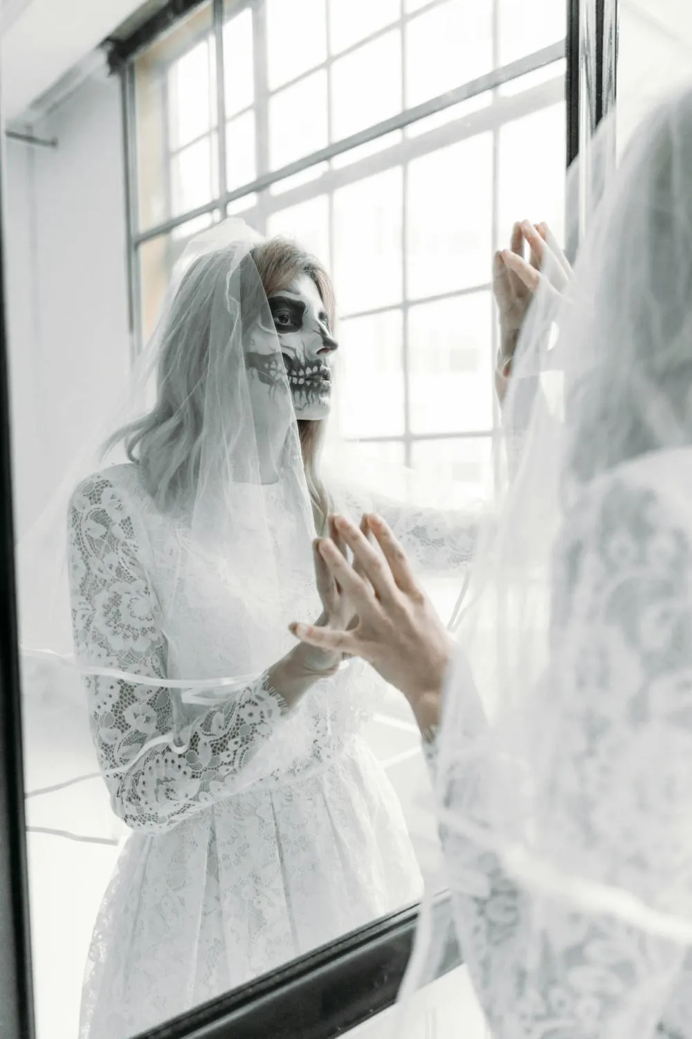 Bride in a Lace Dress Posing Beside a Mirror Free Wallpaper