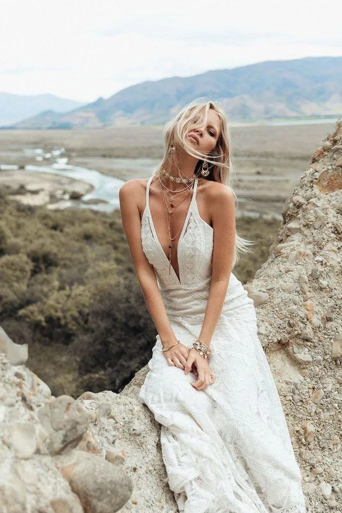 Bride Sitting on Rocks Wearing a Wedding Dress Hd Wallpaper