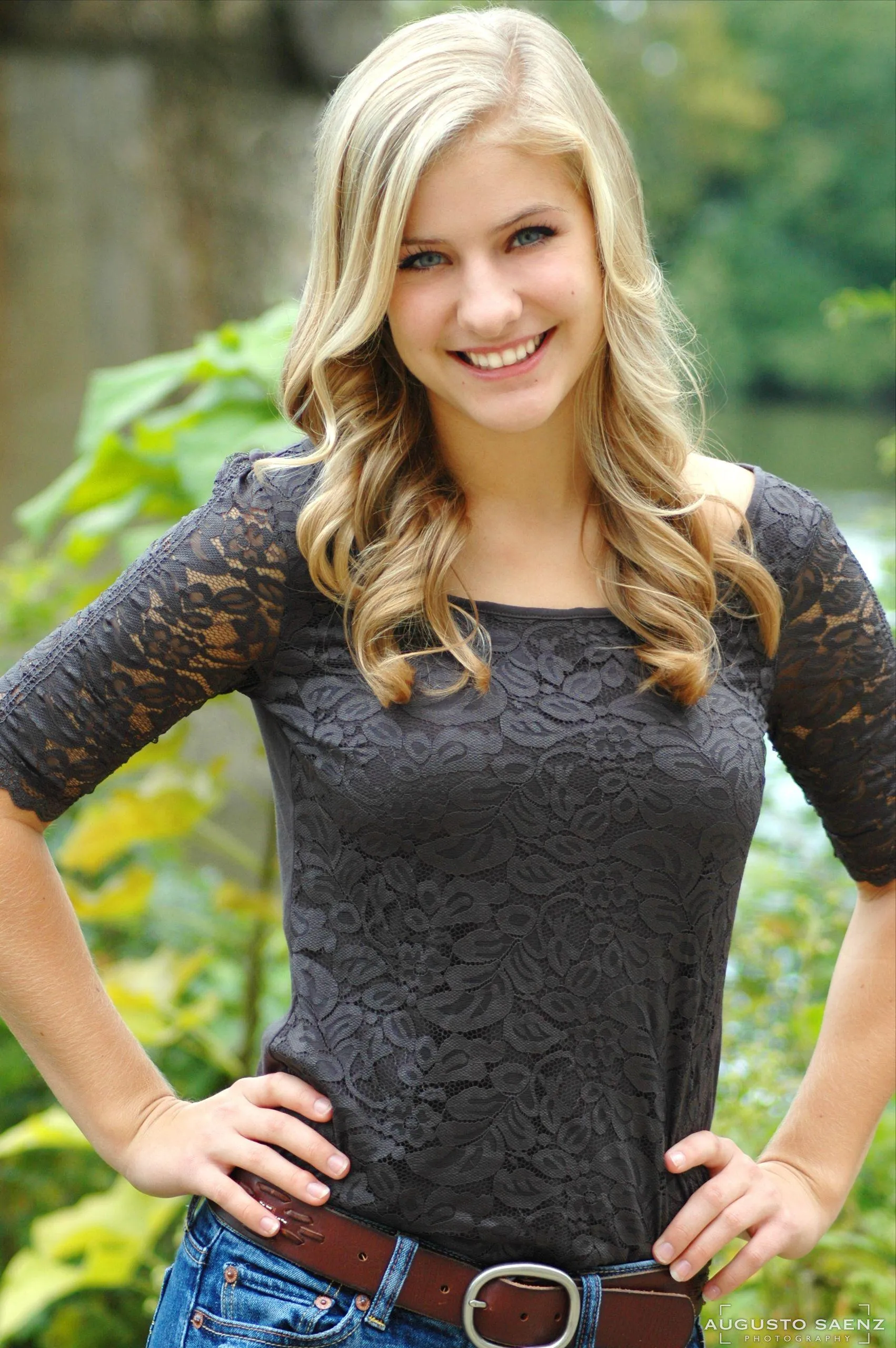 Casual Outdoor Portrait of a Happy Woman with Hands on Hips
