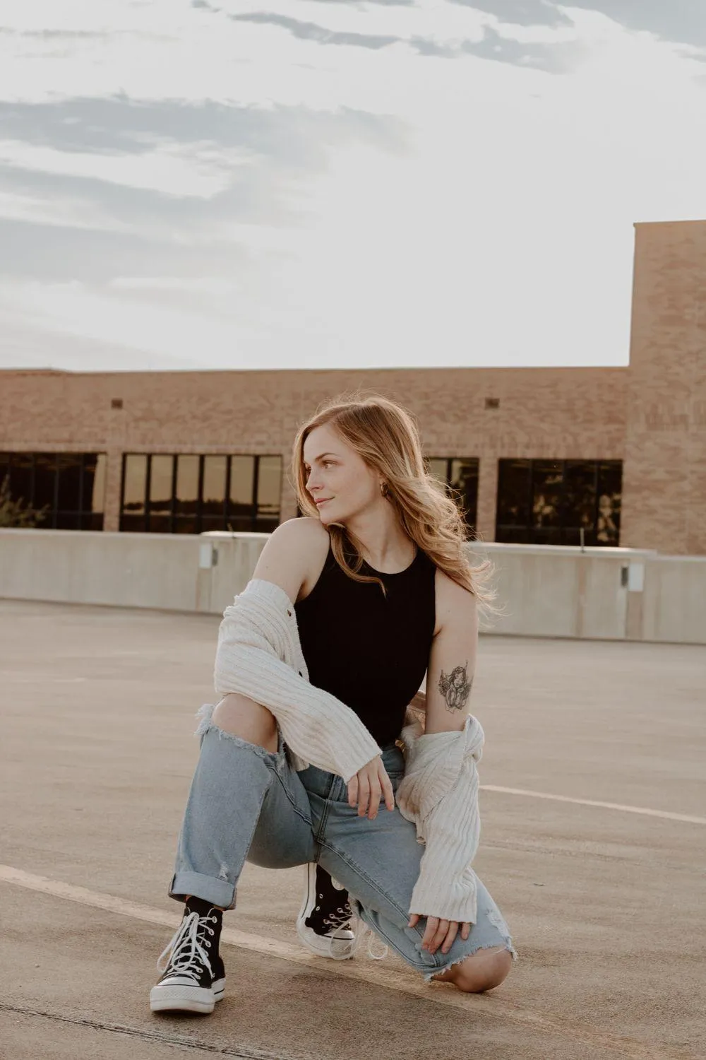 Casual Woman Posing Confidently in a Rooftop Urban Setting