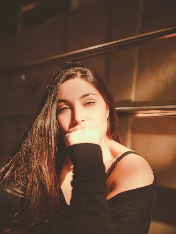 Casual Woman Sitting on the Stairs Under Soft Warm Lighting