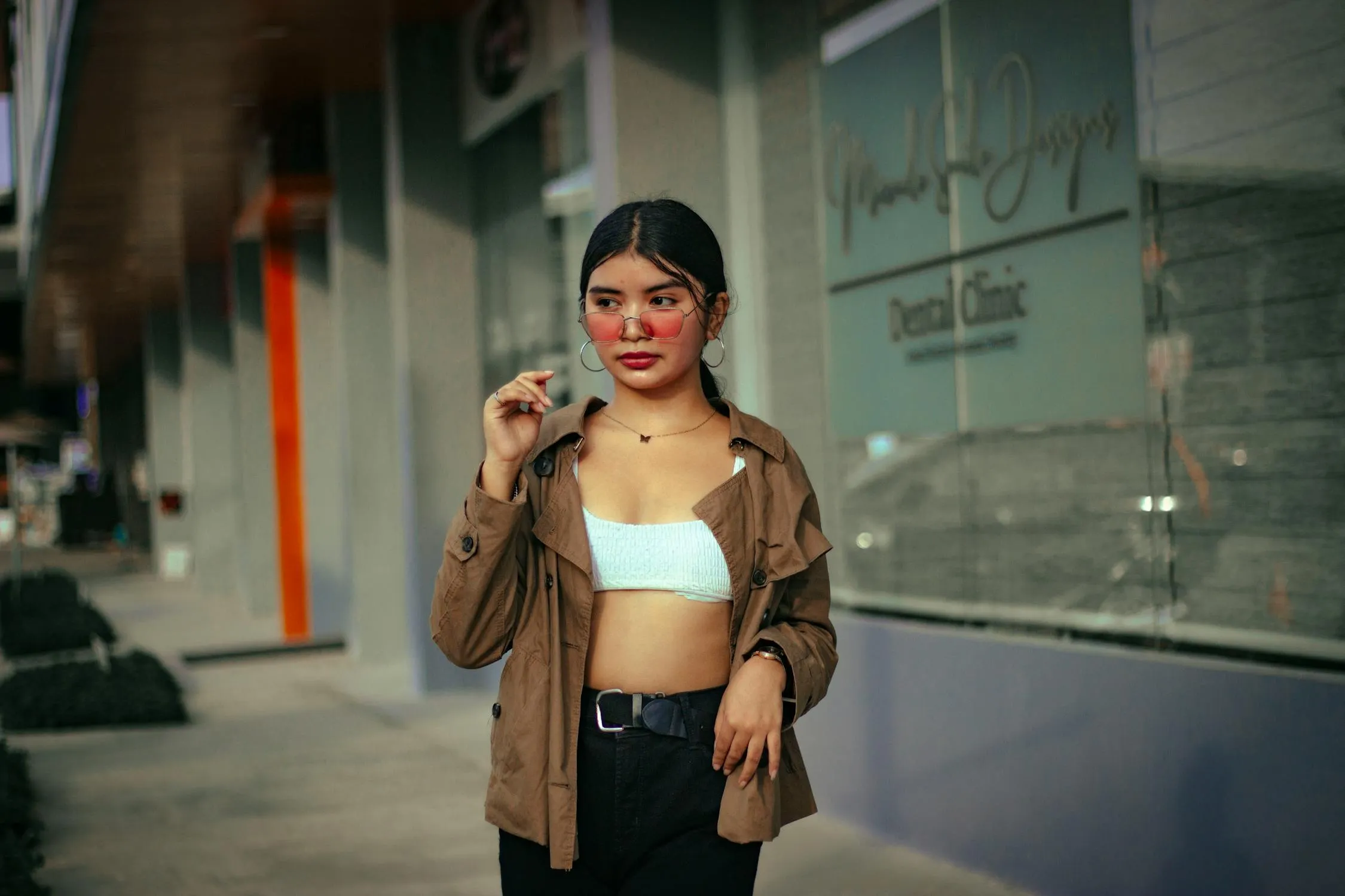 Casual Young Woman Standing Outdoors in Jacket and White Top