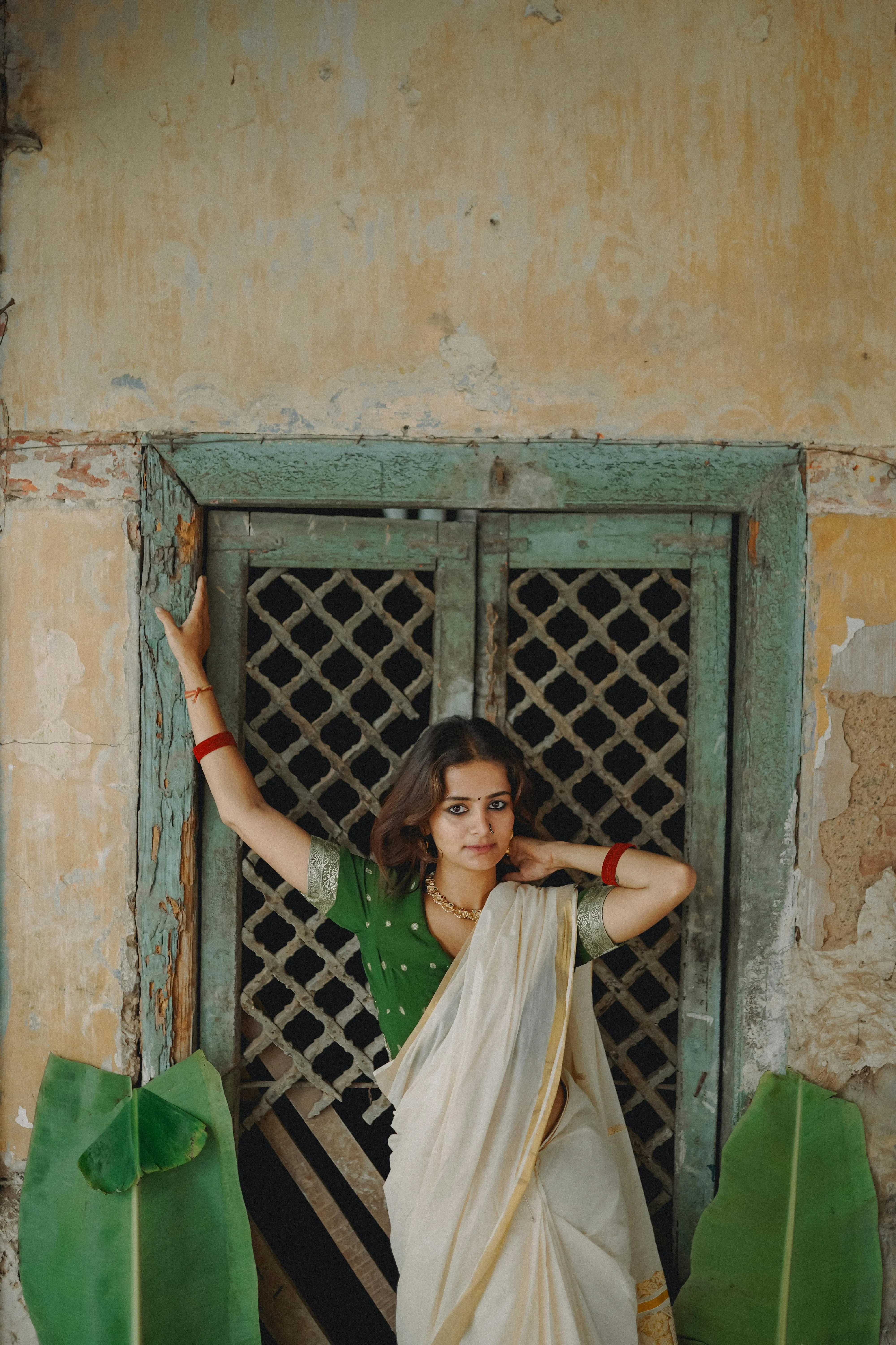 Charming Young Woman in White Saree Standing by Window Image