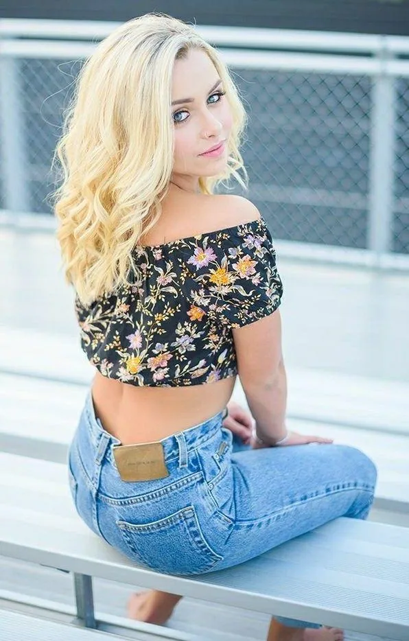 Cheerful Model in a Floral Off Shoulder Top Sitting Outside