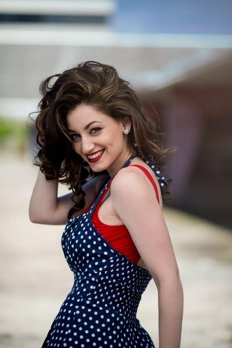 Cheerful Woman in a Polka Dot Dress Smiling and Posing Image