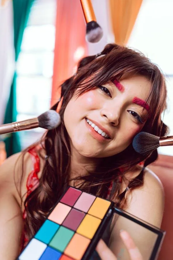 Cheerful Woman Smiling While Holding a Colorful Makeup Kit