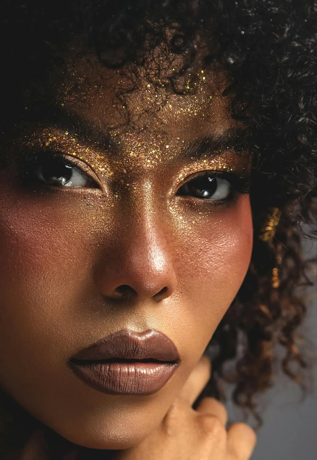 Close Up Portrait of a Model with Golden Artistic Makeup