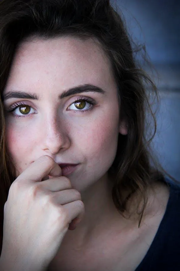 Close Up of a Thoughtful Woman with Her Hand Near Her Mouth