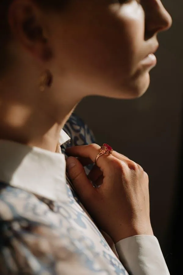 Close Up of a Woman Adjusting Her Necklace in Soft Light