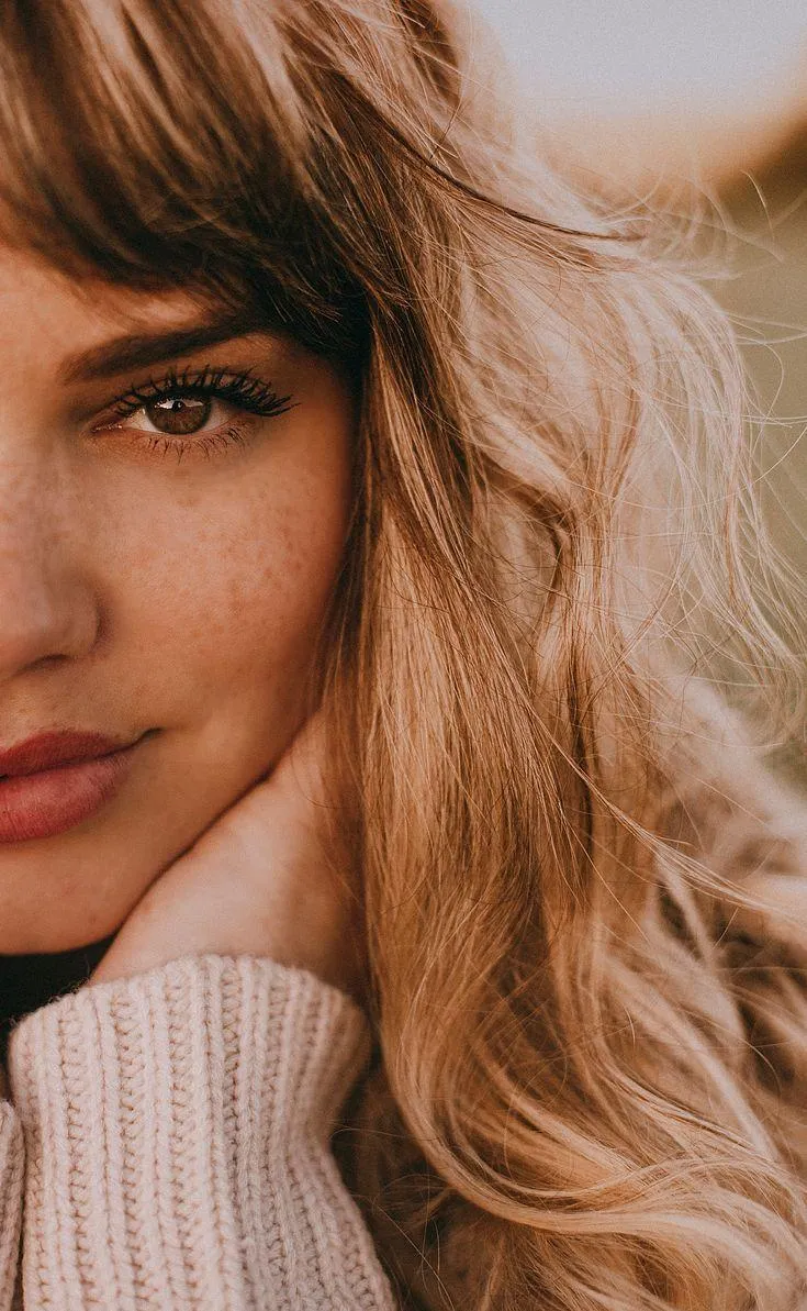 Close Up of a Woman with Golden Hair and a Cozy Sweater