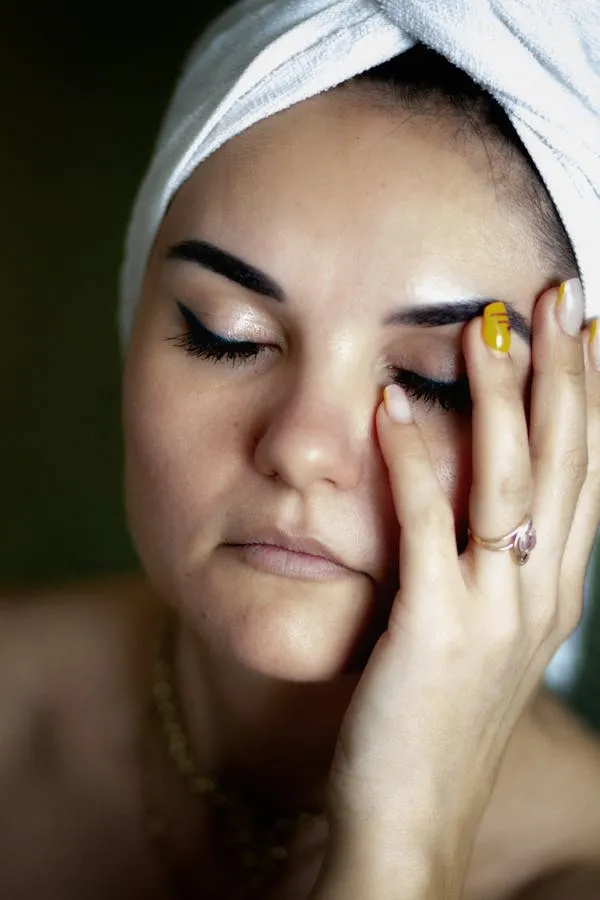 Close Up of a Woman with Towel on Her Head Touching Her Face