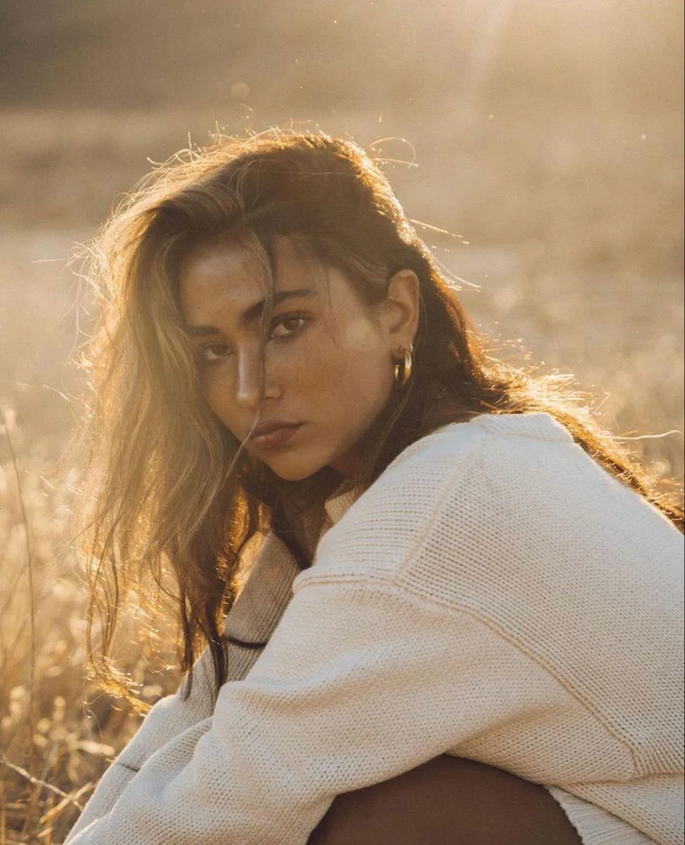 Close Up of a Woman in a White Sweater with an Intense Gaze