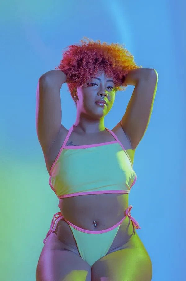 Colorful Lighting on Model Wearing a Bikini with Curly Hair
