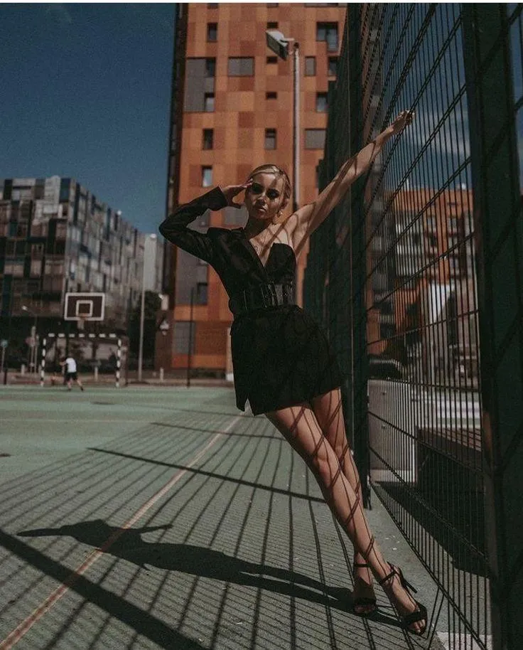 Confident City Girl Posing Stylishly on an Urban Road Image