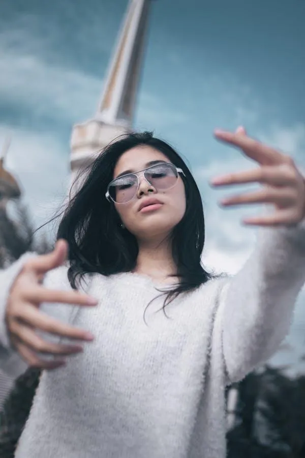 Confident Girl in a Hoodie Posing Outdoors with Attitude