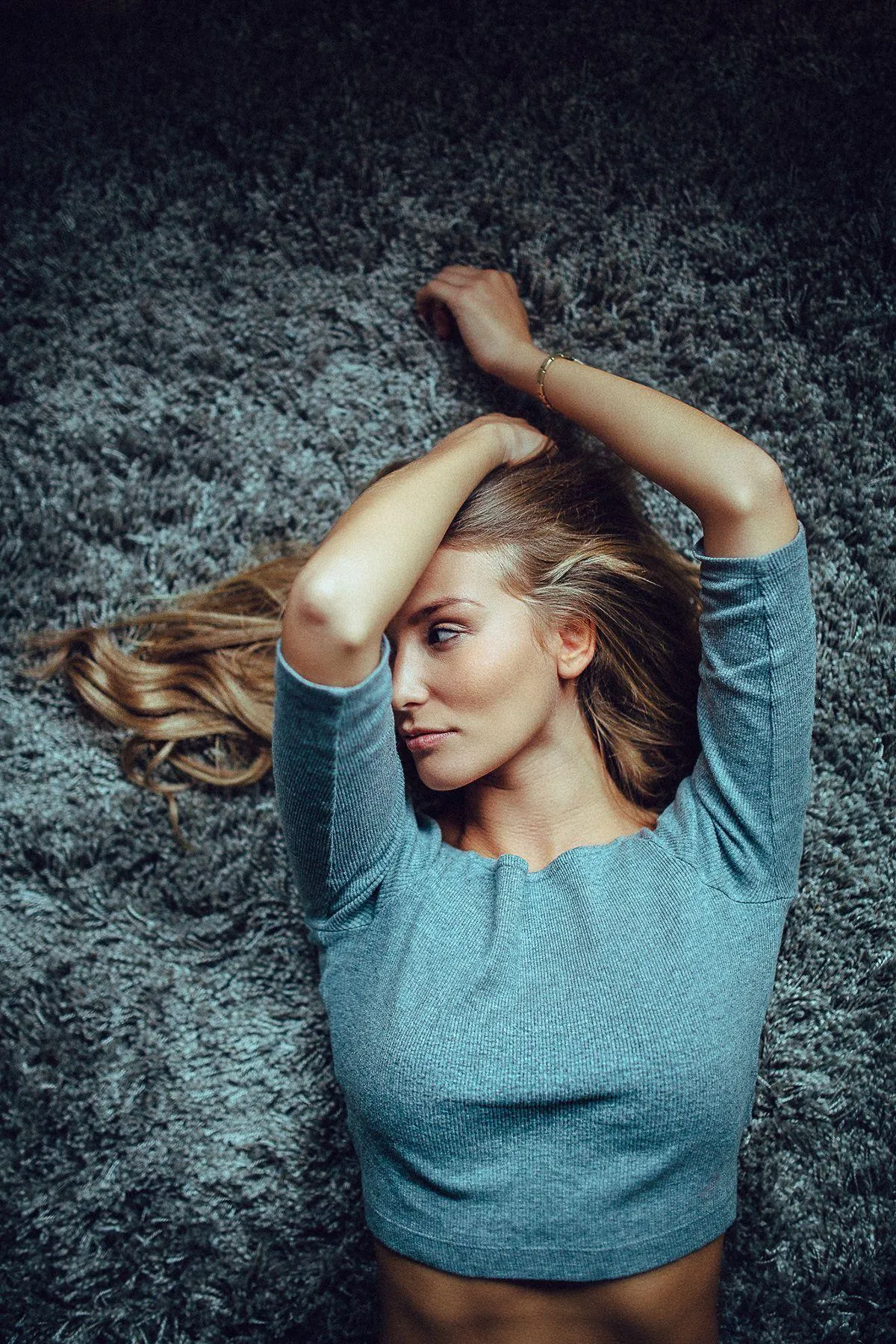 Confident Girl Sits Beside a Motorbike on the City Pavement