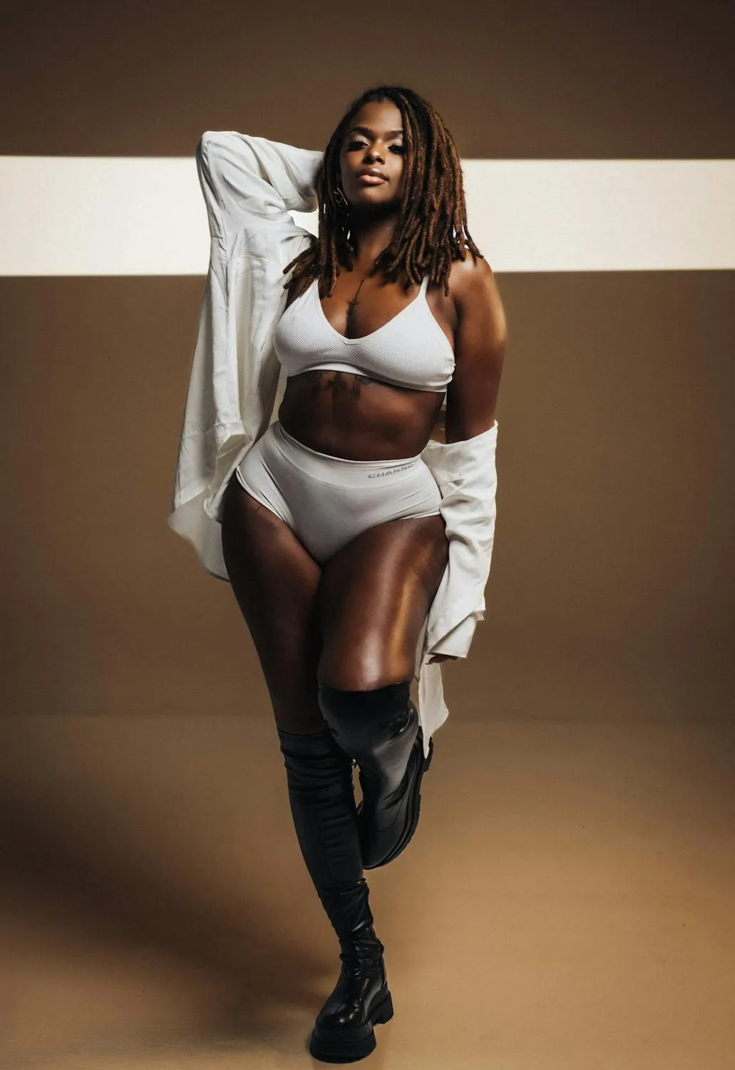 Confident Plus Size Model Posing in Stylish White Outfit